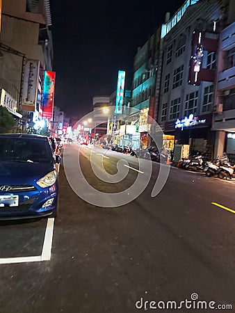 city â€‹â€‹street view of the most crowded of vehicles, street lights and shops roadside shops at night Editorial Stock Photo